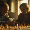Two friends playing board game at sunlit kitchen table with shallow depth of field on game pieces